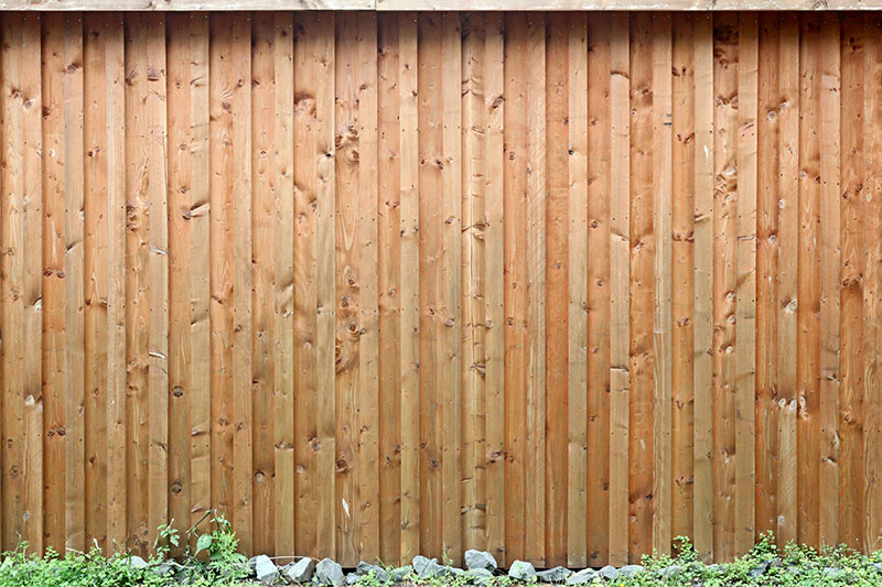 Neatly implemented tall wooden fence.