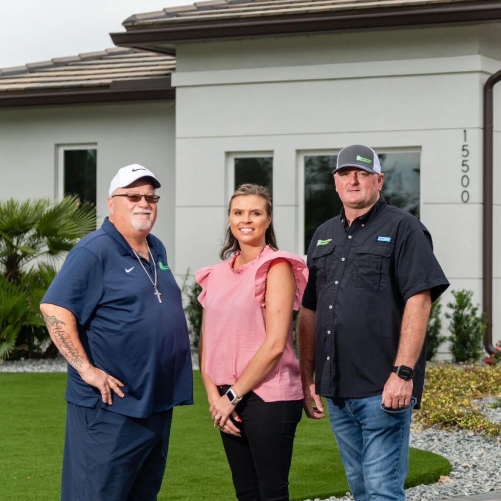 The three Randolph Outdoor owners standing in front of a house.